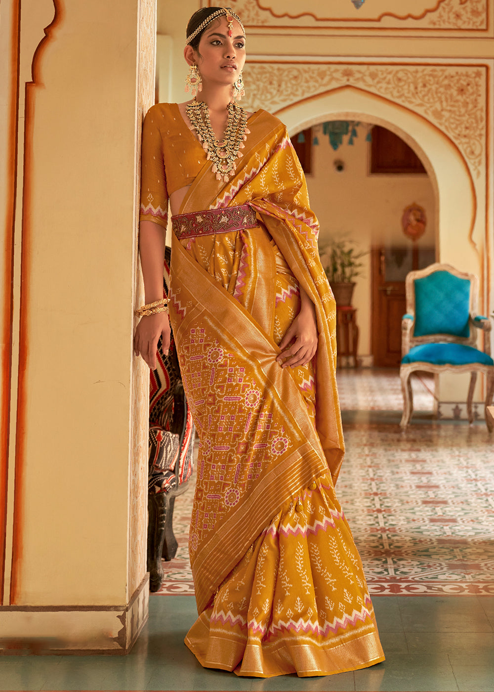 Mustard yellow silk saree with green cutwork embroidery and mirrorwork
