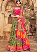 OLIVE GREEN HAND CRAFTED PATOLA SILK LEHENGA WITH EMBROIDERED SILK BLOUSE