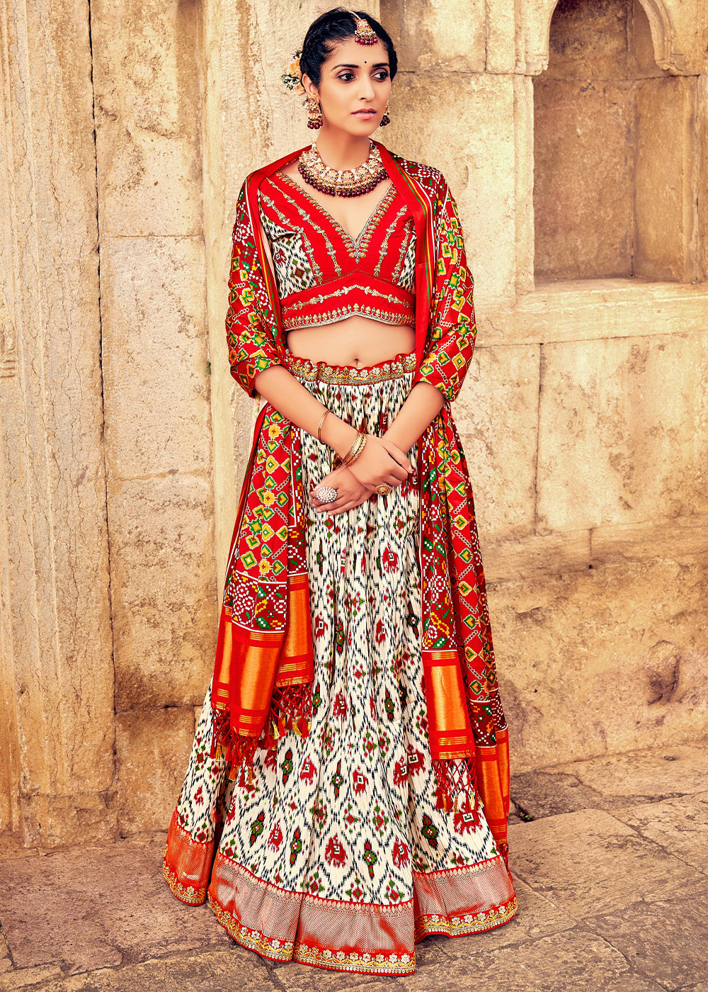 WHITE & RED HAND CRAFTED PATOLA SILK LEHENGA WITH EMBROIDERED SILK BLOUSE