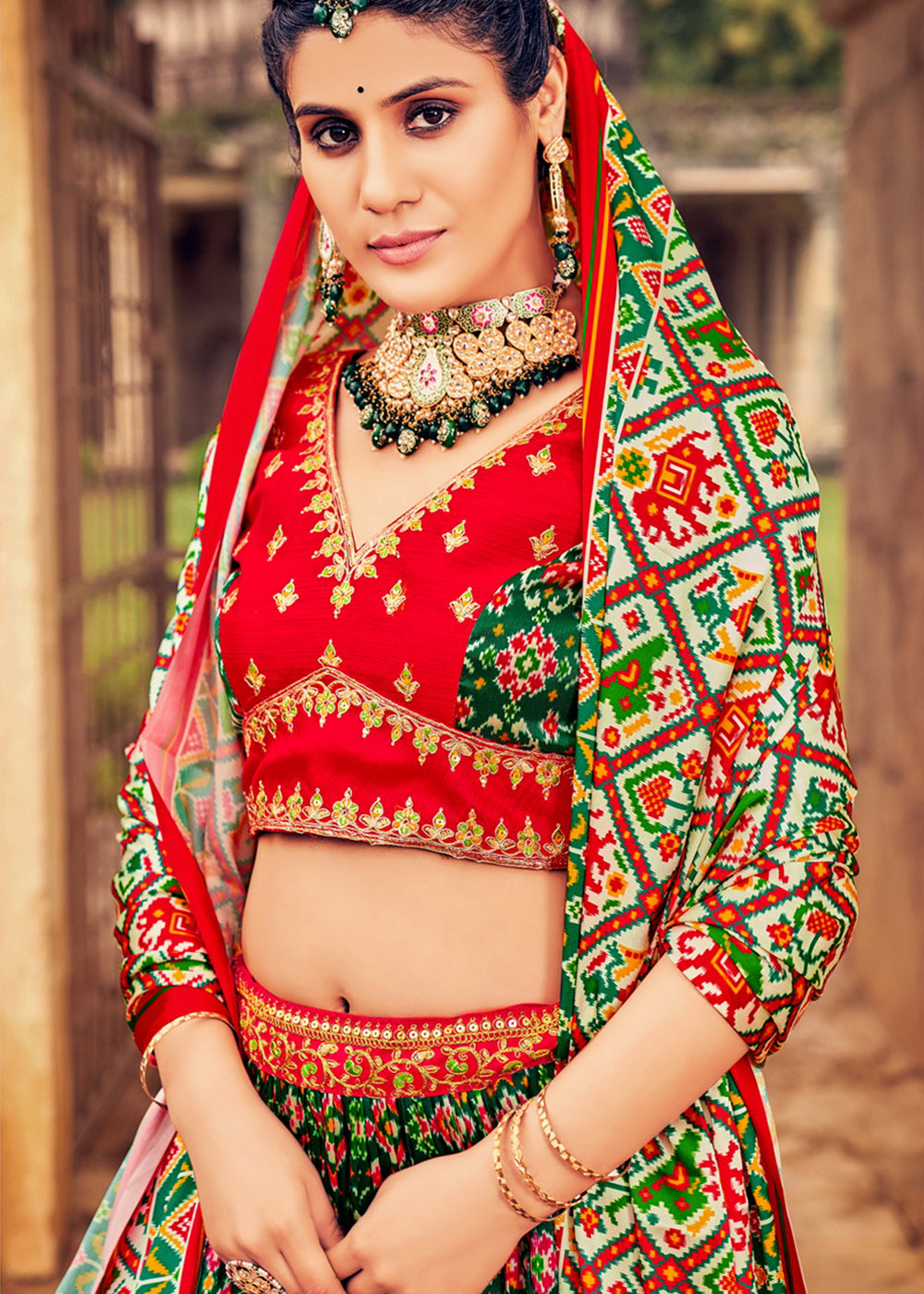 PINE GREEN HAND CRAFTED PATOLA SILK LEHENGA WITH EMBROIDERED SILK BLOUSE