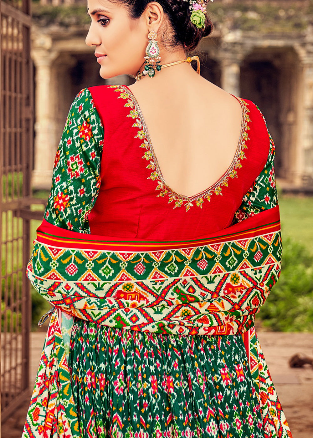 PINE GREEN HAND CRAFTED PATOLA SILK LEHENGA WITH EMBROIDERED SILK BLOUSE