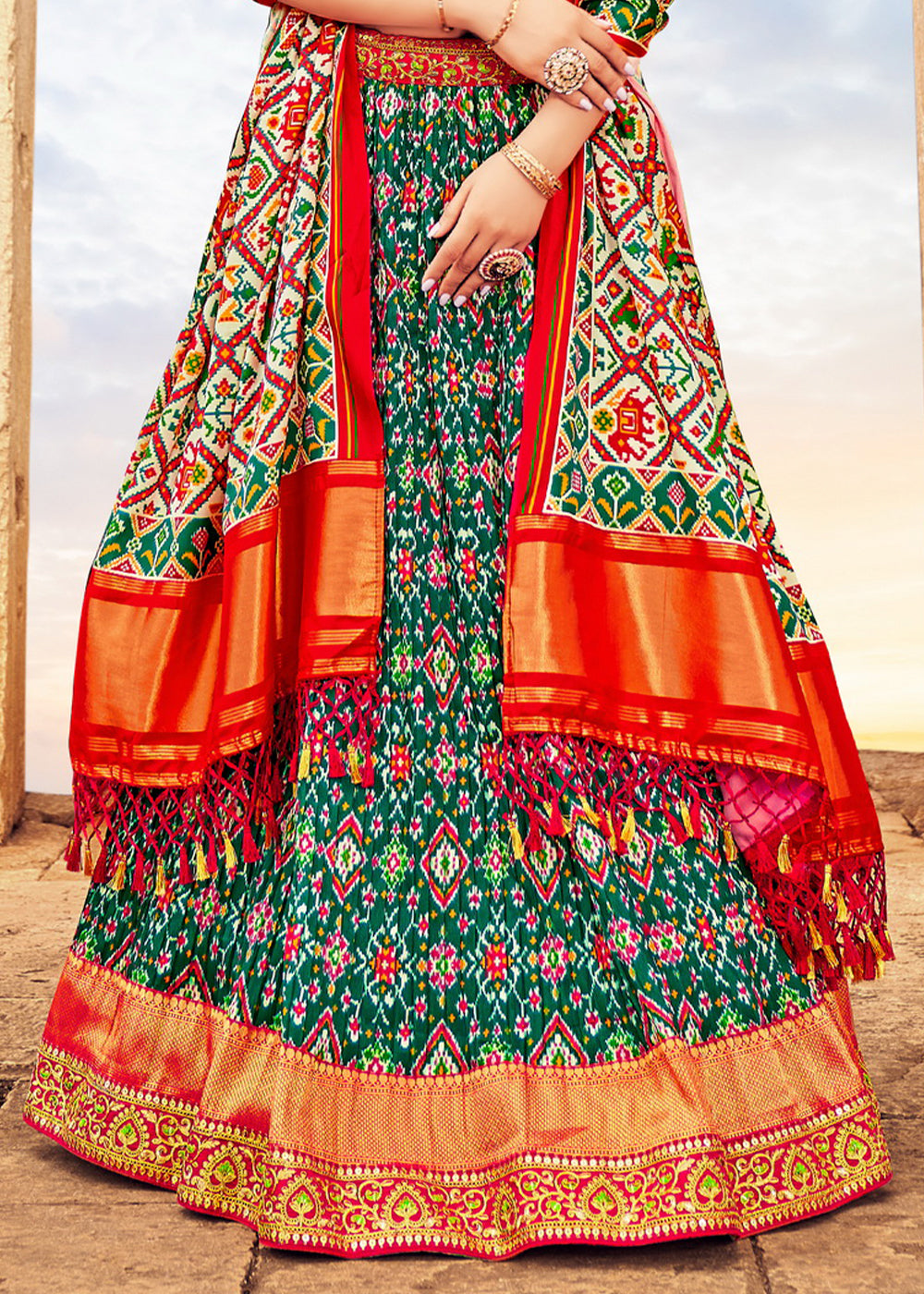 PINE GREEN HAND CRAFTED PATOLA SILK LEHENGA WITH EMBROIDERED SILK BLOUSE